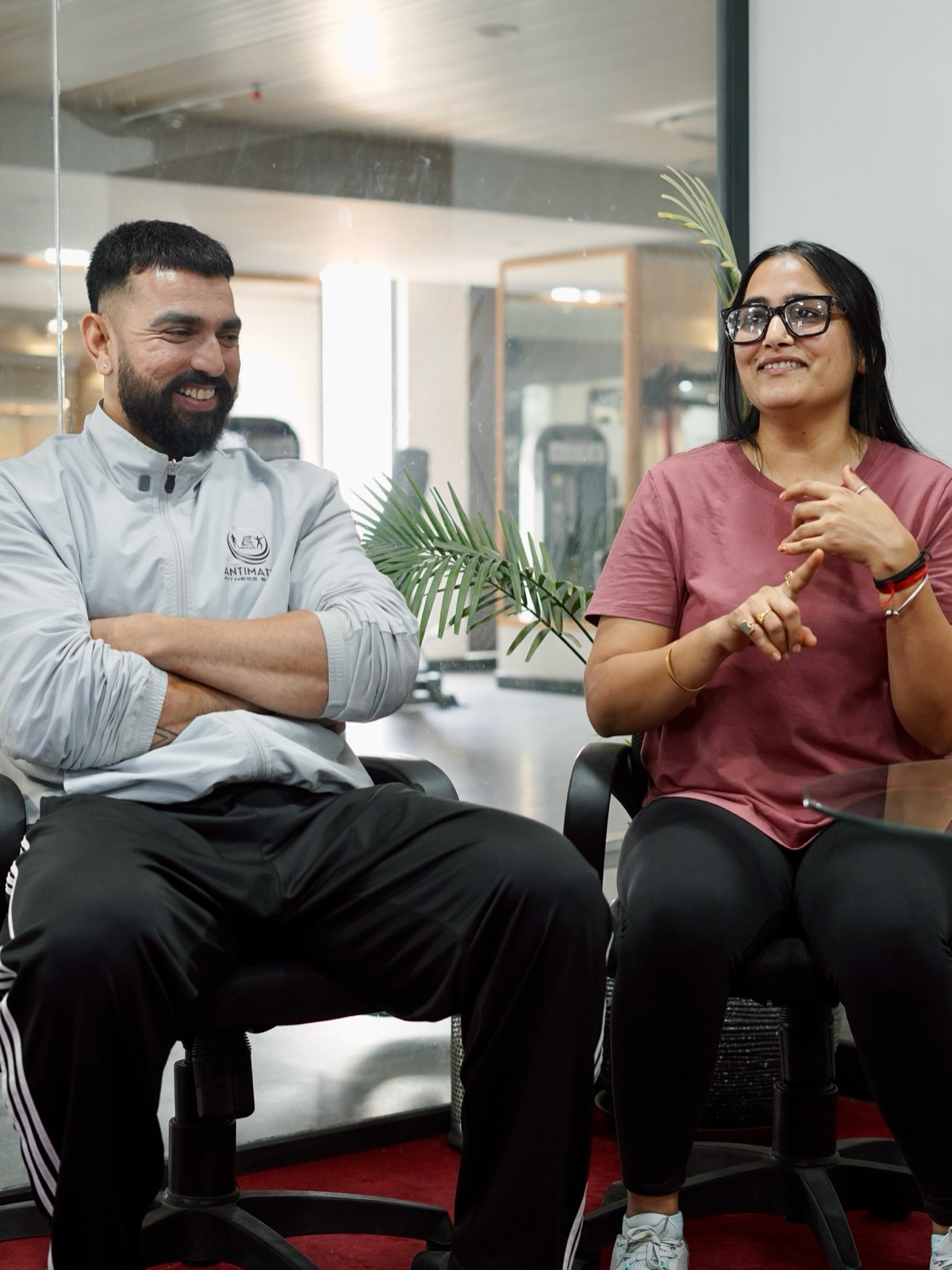 antimatterfit coach and member talking at the gym